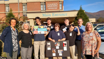 Group of people stand outside of hospital in Sylva.