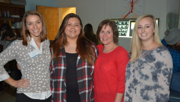 Two female students and two female instructors pose for a photo inside SCC's medical sonography lab.