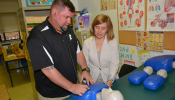 Man and woman standing behind table