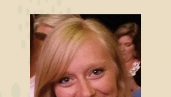 Ashley Chastain smiling. she's wearing a black and white plaid shirt