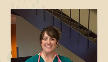 Melissa McCubbin wearing her green scrubs and pink stethoscope