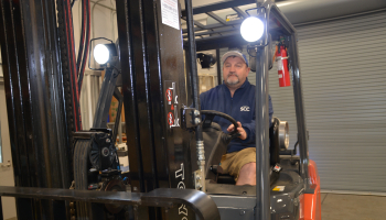 Man operates forklift