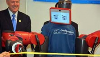 Photo of Baxter the Robot cutting a ribbon during the grand opening of Southwestern Community College’s Advanced Manufacturing Education Lab
