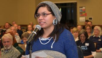 Young lady speaks into a microphone