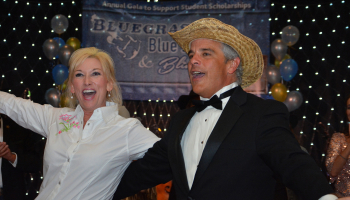 Man and woman celebrate in front of the stage during the gala.