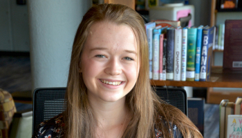 Woman sits in library