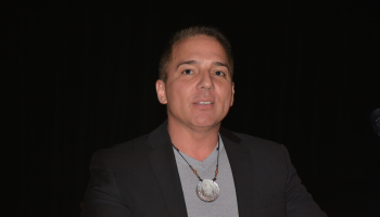 Man speaks from a podium.