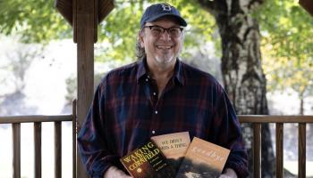 Chris Cox is shown with all three books he's written.