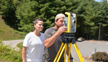 SCC instructors check out surveying equipment.