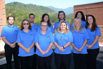 A group of SCC students pictured in front of a mountain landscape.