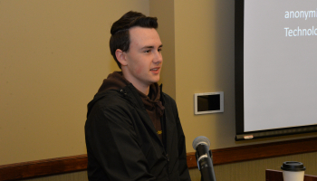 Student speaks to a crowd in the fall.