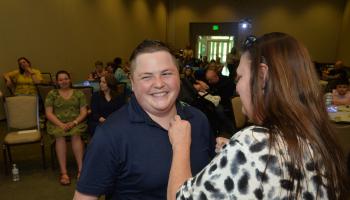Brittany Martin receives her pen from program coordinator Crystal Rhynes