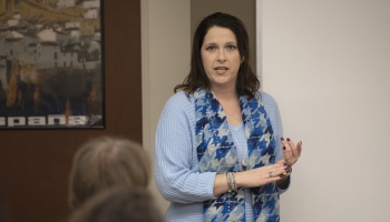 Woman speaks in front of a classroom