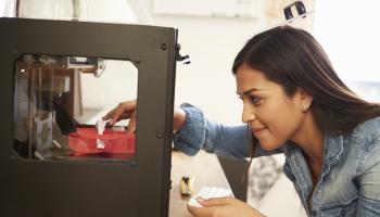 Young lady works with a 3D printer