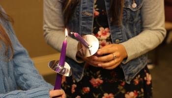 Inductees light each other's candles