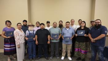 Graduates display their certificates