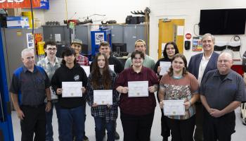SCC students stand with instructors and college officials