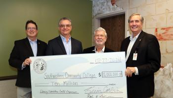 Men hold large check