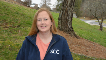 Woman stands outdoors