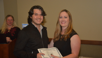 Student received a certificate from his instructor.