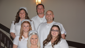 Jackson County residents standing and smiling in all white.