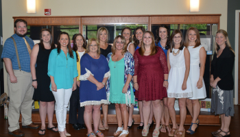 Students standing and smiling