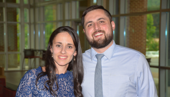A woman and man smiling at the camera