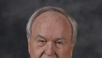 Paul Holt is pictured in a suit and tie.