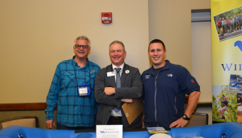 Three men at a job fair