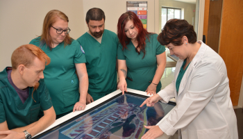 Female instructor providing demonstration to Respiratory Therapy students