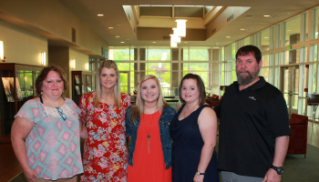 Medical assisting students have picture taken before pinning ceremony.