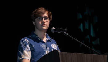 Student speaks from podium during gala