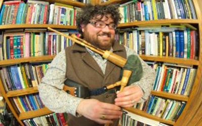 Tiber Falzett holding bagpipes
