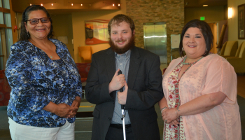 A man stands between two women inside a building on SCC's Jackson Campus.