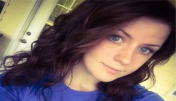 Young brunette woman poses for a selfie