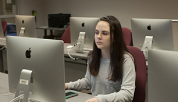A female math instructor speaks to students