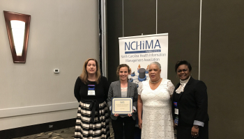 4 women standing, one a scholarship recipient