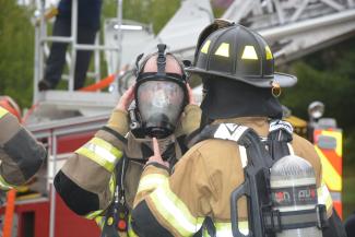 Firemen prepare their gear before a training exercise