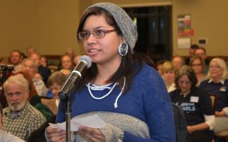Young lady speaks into a microphone