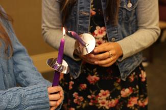 Inductees light each other's candles