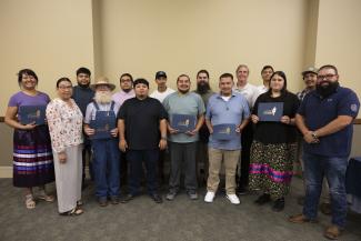 Graduates display their certificates