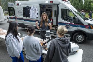 Student stands in front of ambulance