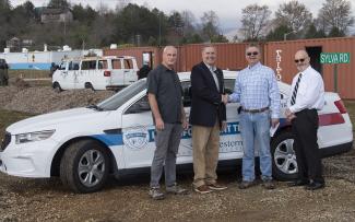 Four men stand in front of a law enforcement training vehicle in Franklin.