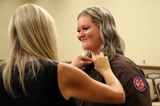 Nurse Aide student receives her pin during a ceremony.
