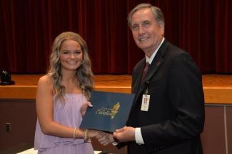 Student receives certificate from SCC President