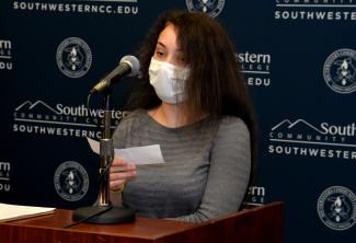 Female student speaks into a microphone.