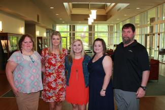 Medical assisting students have picture taken before pinning ceremony.