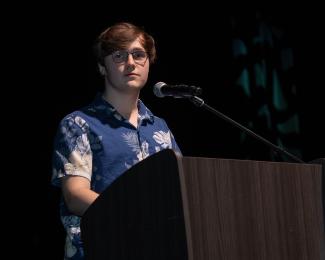 Student speaks from podium during gala