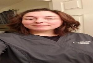 Young woman poses in sonography scrubs