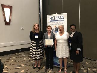4 women standing, one a scholarship recipient